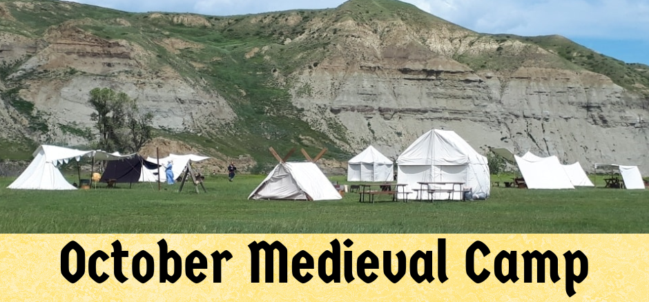 8 White Medieval Tents with Tall dirt hills and a blue sky in the background