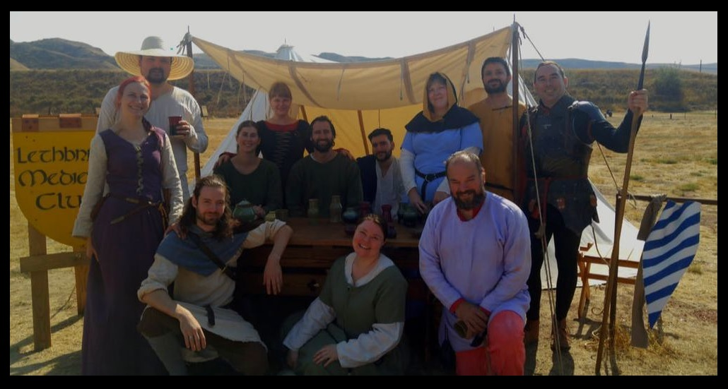 LMC Club Members, dressed in medieval clothing posing in front of a medieval tent